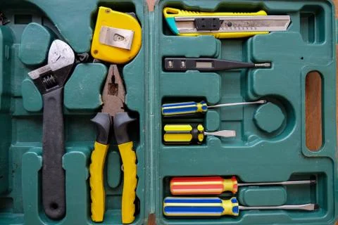 Old square green tool box with manual set tools. Top view Stock Photos