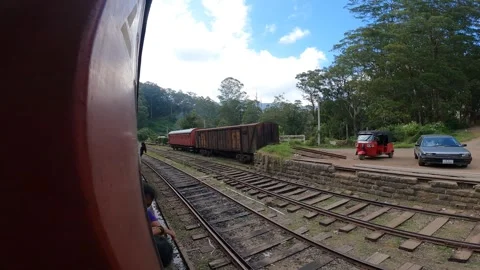 Old Srilankan Train passing through a small village with junk train standing Stock Footage 250879249