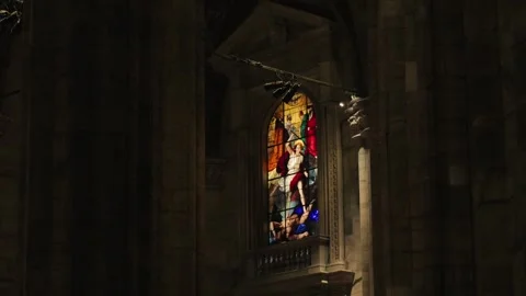 Old stained glass windows in a dark church, saints, bible scenes, religious art 스톡 동영상 329276910