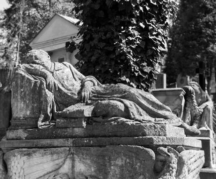 Old statue on grave Stock Photos