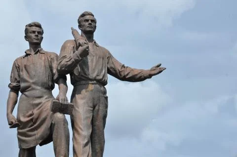 Old statue of two labours from epoch of socialism. Stock Photos