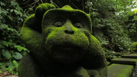 Old statues covered in moss, in an ancient park on Bali, Indonesia, close up Stock Footage 136805857