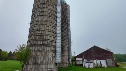 Old stave silos and barn on a farm in Leelanau County, Michigan, USA with fog Stock Footage 344060263