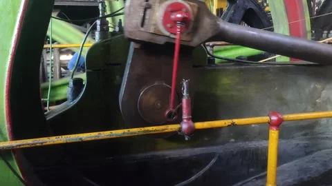 An old steam engine's connecting rod and crank system move in rhythmic precision Stock Footage 309440930