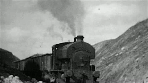 Old steam railway locomotive engine in an ironstone quarry in old B&amp;W film UK Stock Footage 10866769