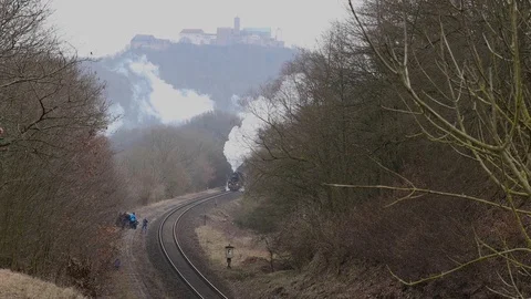 An old steam train in front of the Wartburg Castle in Germany Stock Footage 123597624