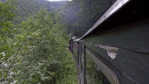 Old steam train going through the mountains Stock Footage 113556527