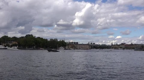 Old steamboat meets two fast motorboats in front of Skeppsholmen Stock Footage 67384785