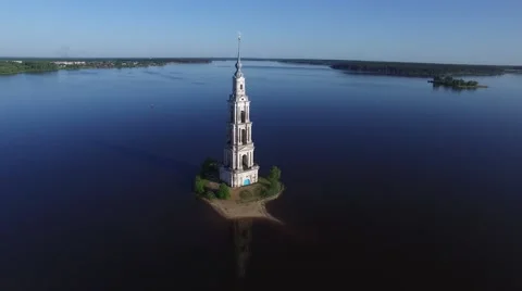 Old steeple sticking out in the middle of the river. Flying around. Stock Footage 63763555