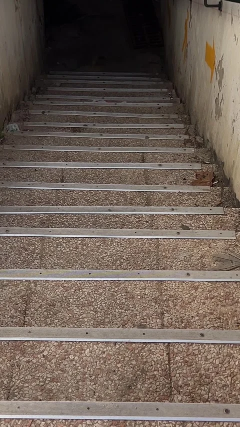 Old steps down into the ground staircase in a building leading down with a Stock Footage 294526997