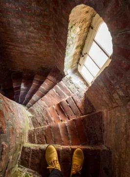 Old steps down from the red brick of the old lighthouse in Lithuania, Klaiped Stock Photos
