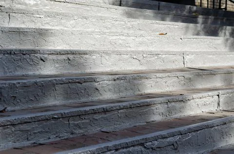The old steps painted gray paint. Rising top of the steps in the sunlight. Fa Stock Photos