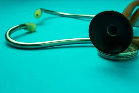 Old stethoscope on blue background Stock Photos