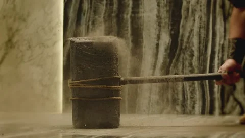 Old stone age large hammer hitting floor and splashing dust Stock Footage 198817848