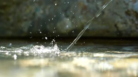 Old stone and metal drinking water fountain in a forest in Europe slow motion Stock Footage 203898017