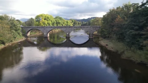 Old stone arch bridge over river in countryside Stock-Footage 166694265