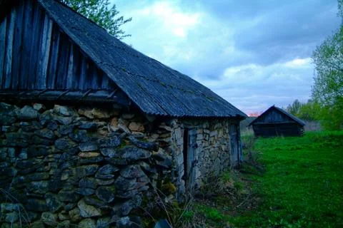 Old stone barn in the spring evening Stock Photos