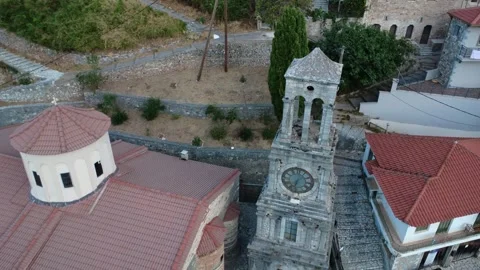 Old Stone Bell Tower With Clock Beside Orthodox Church in Mountain Greece 動画素材 326353814