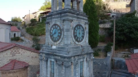 Old Stone Bell Tower Revealed Above Narrow Alleys in Mountain Village Greece Stock Footage 324867586