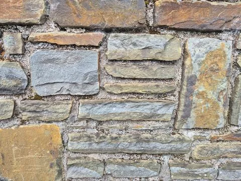 Old stone brick wall texture with weathered mortar Stock Photos