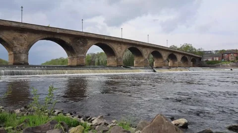 Old Stone Bridge With Arches Across the River in Cloudy Weather Stock Footage 246939041