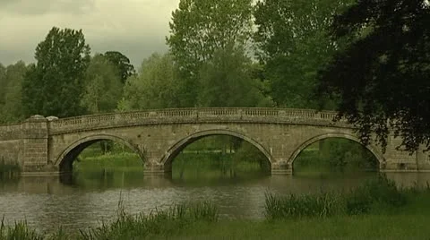 Old stone bridge over river with caravans crossing. Stock Footage 10579974