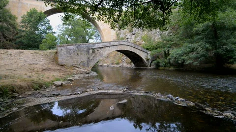 Old stone bridge over river La Cure in the Pierre-Perthuis, Burgundy, France, Eu Stock Footage 55390491