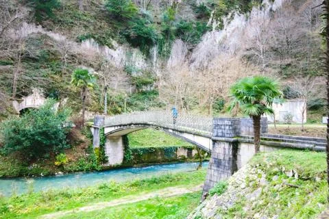Old stone bridge over the river on the background of beautiful nature Stock Photos
