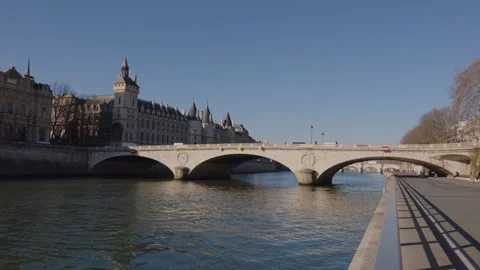 Old stone bridge over Seine River in Paris, France with Pedestrians and Stock Footage 254711878