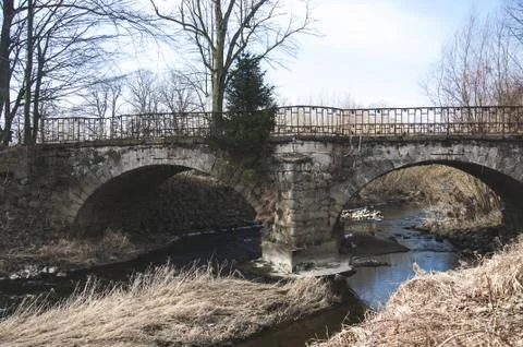 The old stone bridge with two arcs Stock Photos
