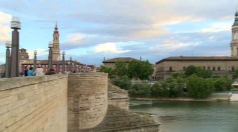 From old stone bridge to view of Basilica by large river, pan right Stock Footage 38716928