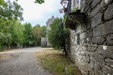 Old stone building wall with balcony and tower Foto stock