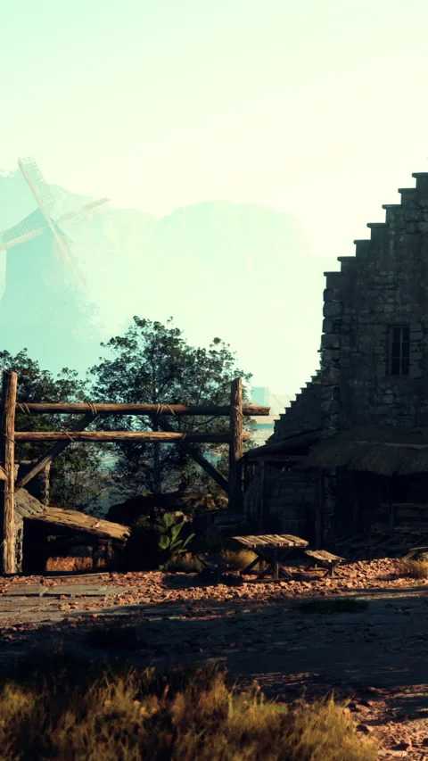 Old stone building with windmill in background during sunset hours Stock Footage 338001967