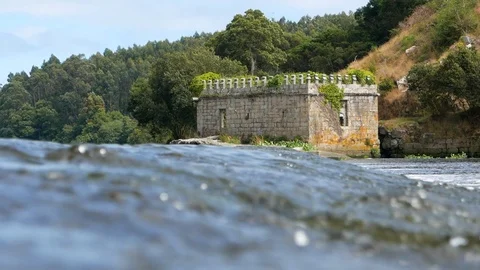 Old stone castle ruin by Ave River in Vila do Conde, Portugal with trees Vídeos de archivo 113607067