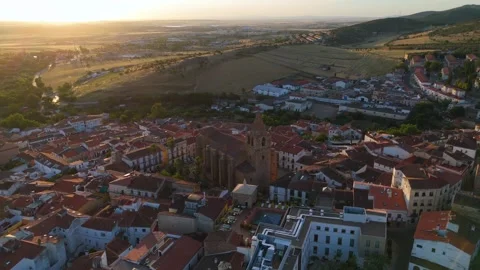 Old stone church surrounded by tiled roofs of Caceres aerial sunrise Spain Stock-Footage 342321191