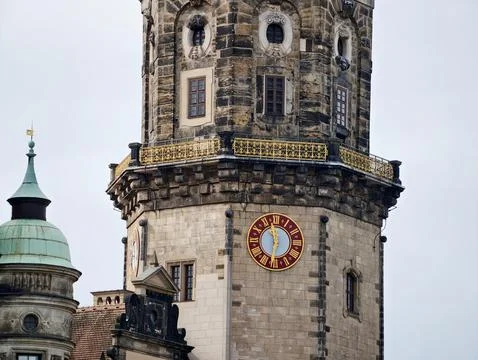 Old stone clock tower under cloudy sky. Weathered masonry tower with decora.. Stock Photos