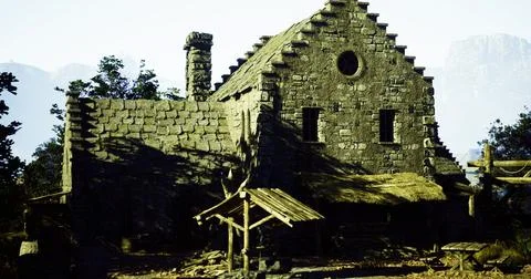 Old stone cottage surrounded by trees in a mountainous landscape Ilustración de archivo