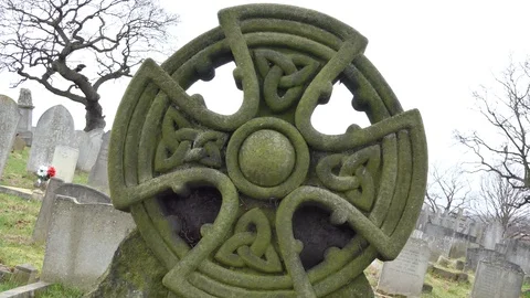 An old stone cross in a graveyard. Stock Footage 104492895