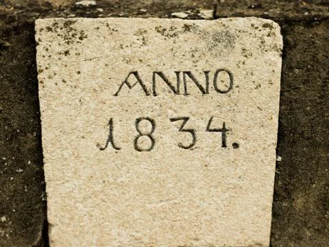 Old stone with engraved year. Stock Photos