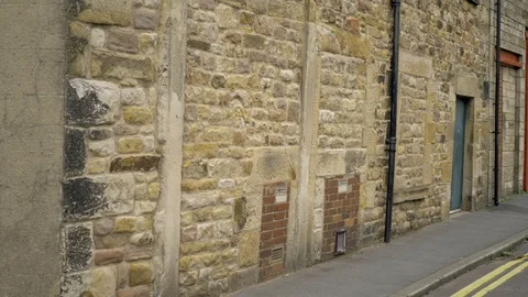 An old stone facade and bricked up doorway Video stock 117433118
