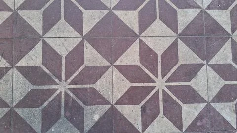 Old stone floor tiles featuring a repeating geometric star pattern design Stock Photos