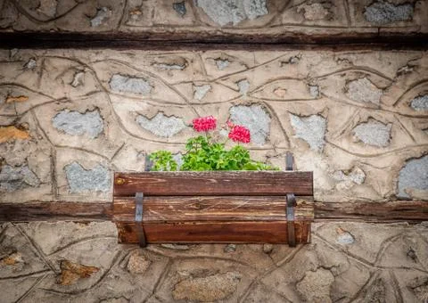 Old Stone House Wall With Flowers in The Pot Stock Photos