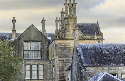 Old stone Irish building with multiple chimneys Stock Photos