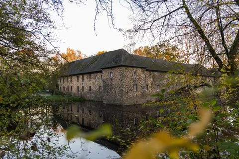 Old stone mill on the bank of a river in autumn, Stock Photos