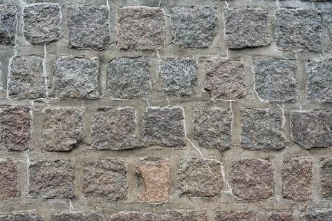 Old stone pavement with mortar joints forming a textured walkway surface. Stock Photos