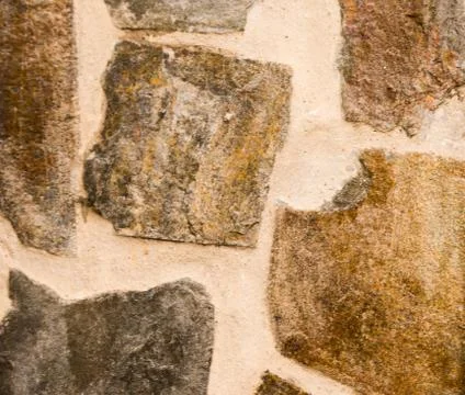 Old stone placed in the wall, interesting and original background Stock Photos