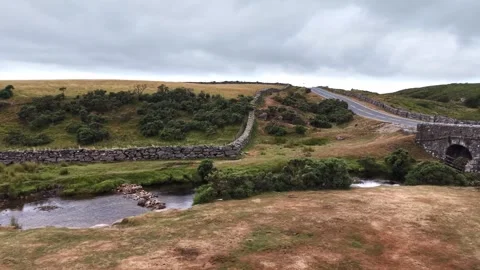 Old stone road bridge over stream on Dartmoor Stock Footage 340517851