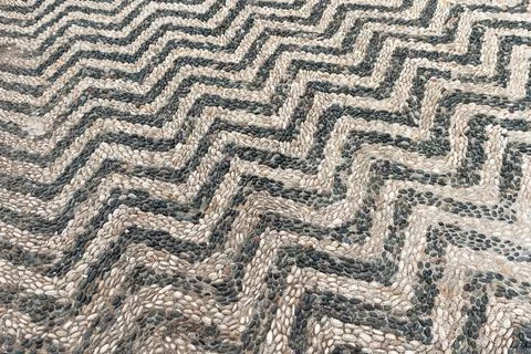 Old stone road pavement, background texture. Mosaic with striped pattern Stock Photos