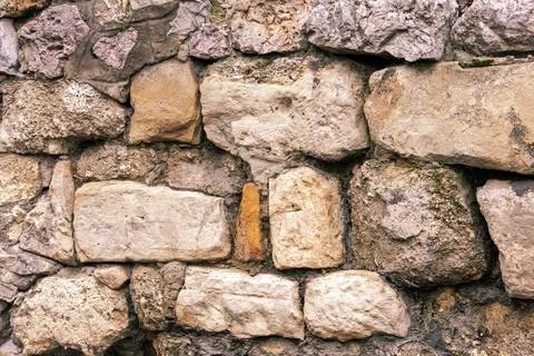Old stone rocks wall pattern outside in nature Stock Photos