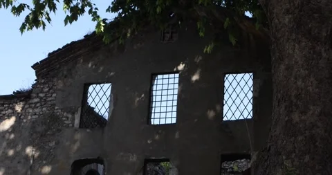 Old stone ruin with barred windows in dappled shade, Istanbul daylight. Stock Footage 320028121